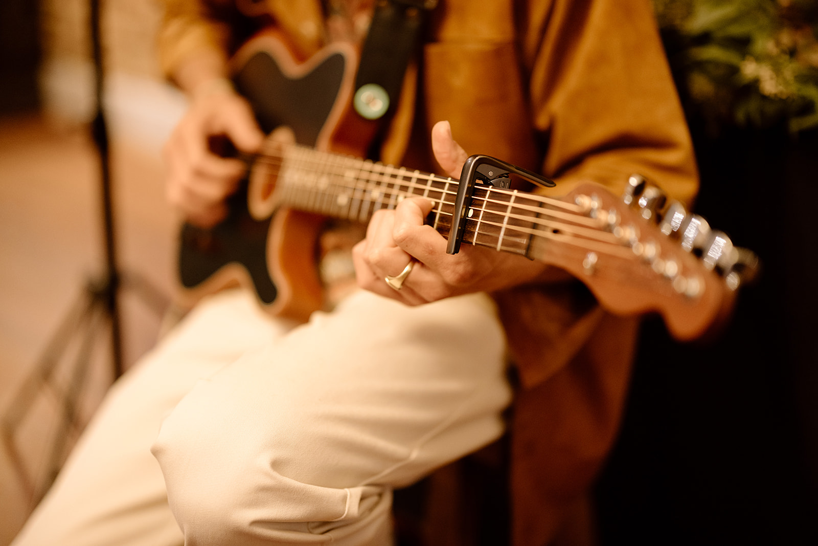 Close-up of hands playing acoustic guitar