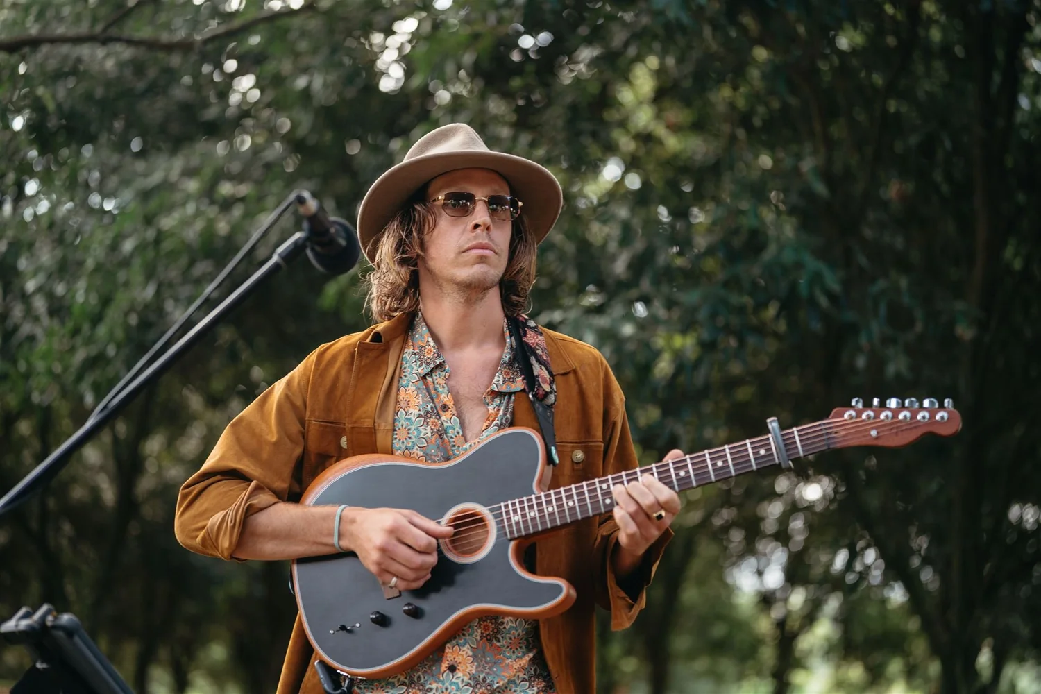 Solo acoustic musician performing outdoors